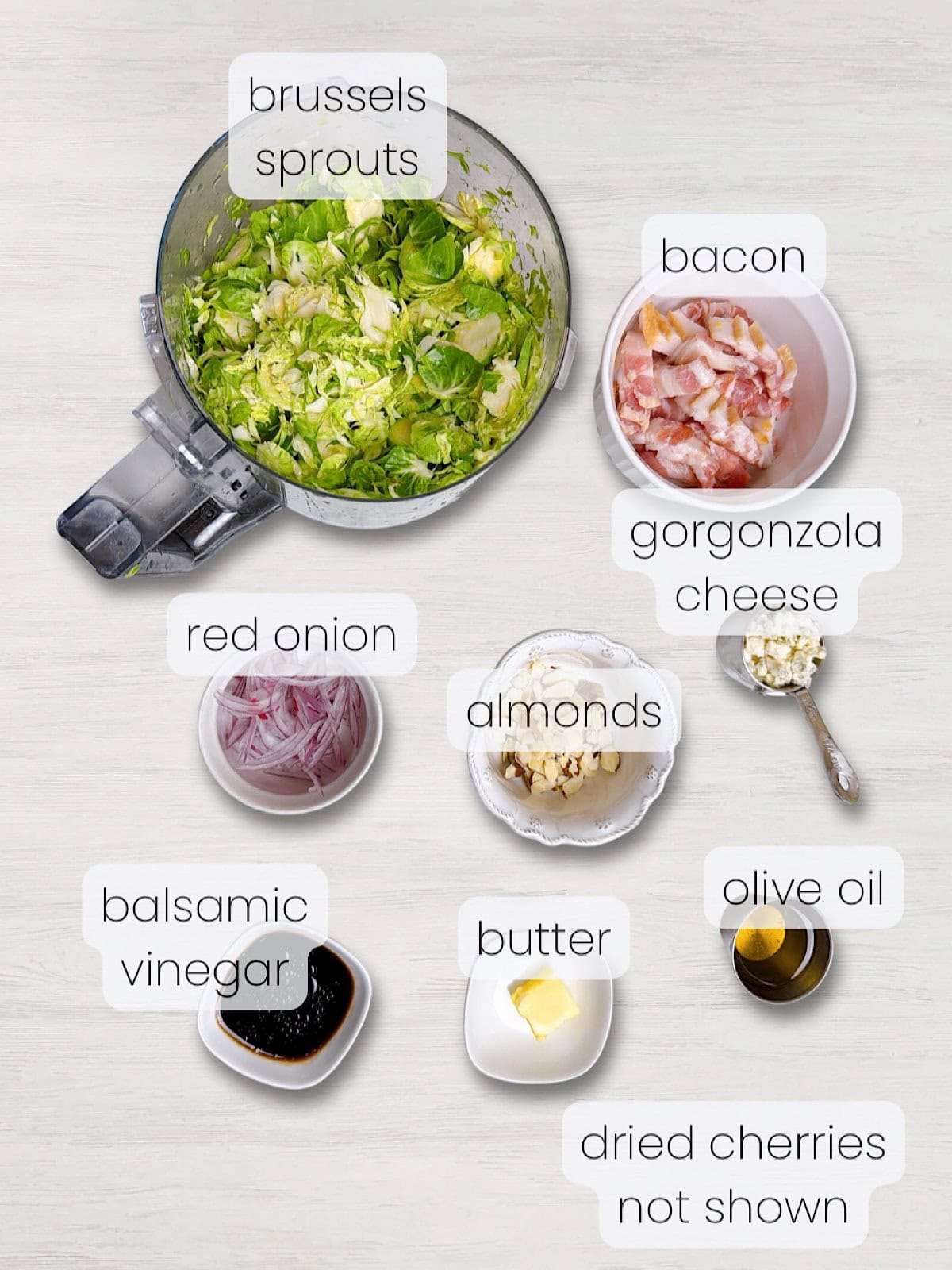 A labeled image of everything needed to make the brussels sprouts with bacon salad.
