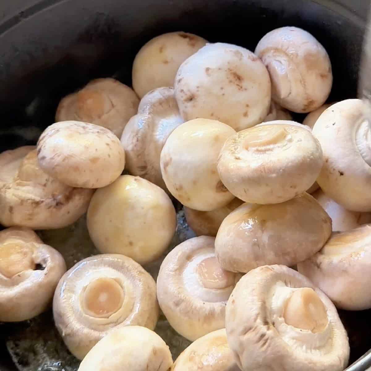 Sauteeing mushrooms in butter.