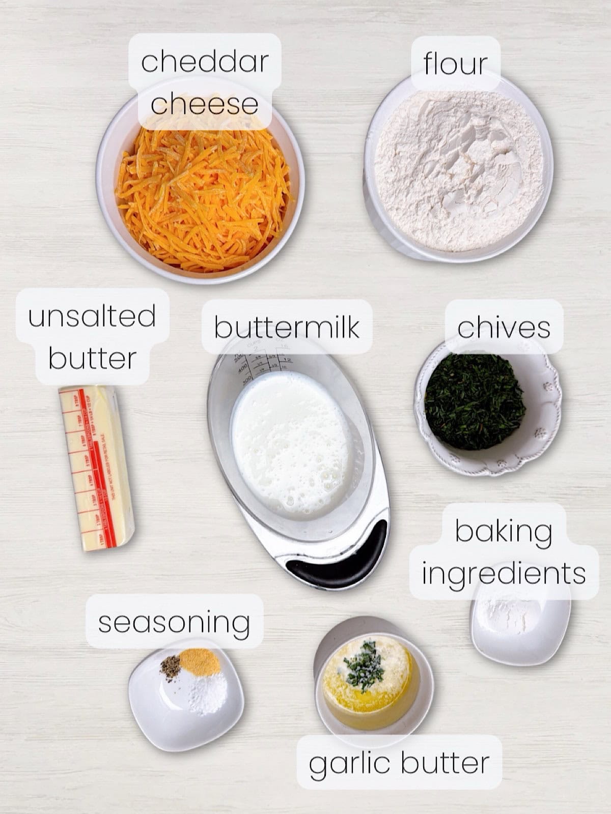A labeled image of everything needed to make cheddar chive drop biscuits.