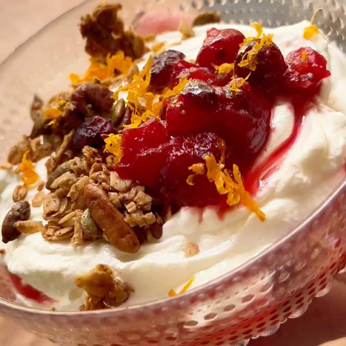 Cranberry compote served over yogurt with pecan granola and orange zest.