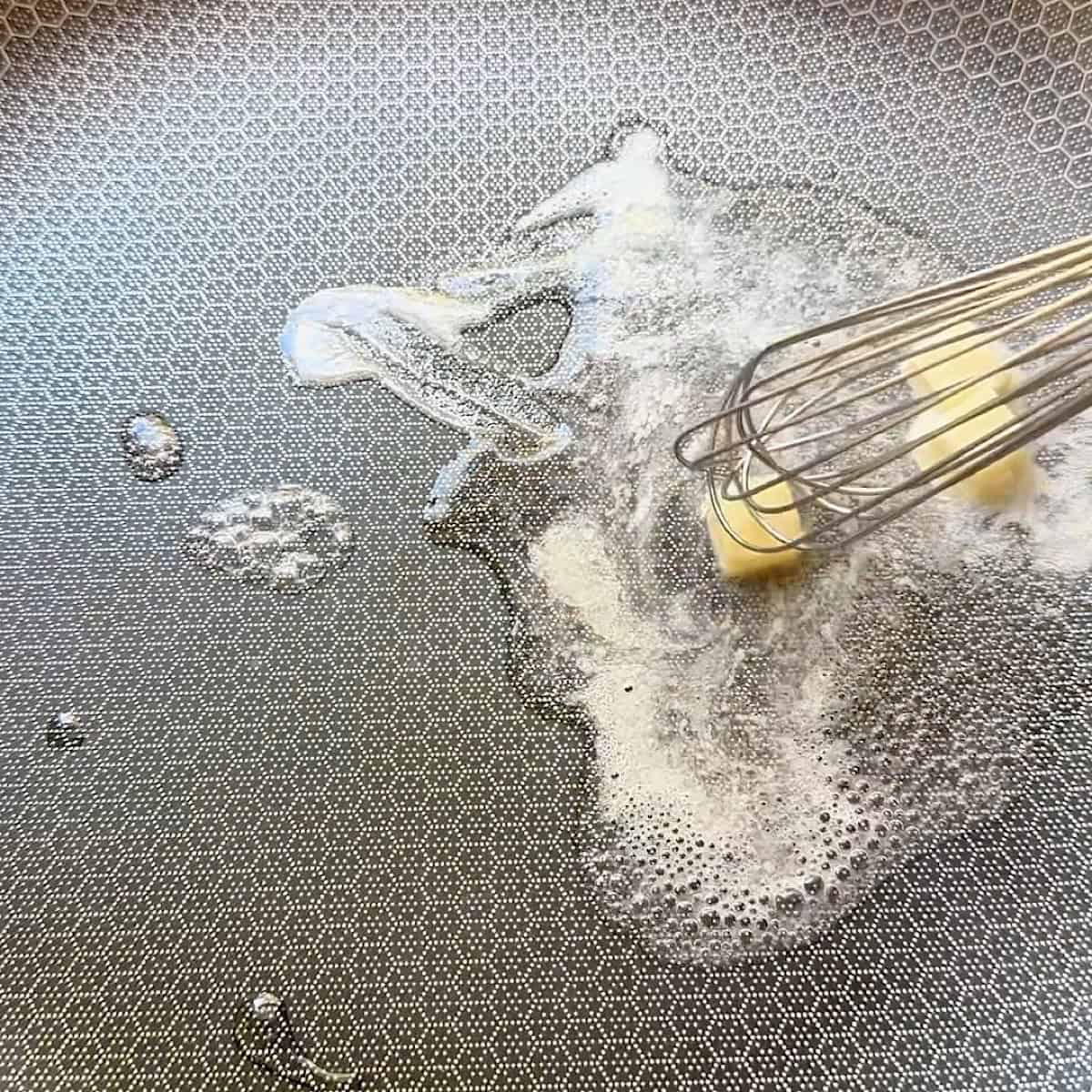 Butter melting in water for buerre fondue.