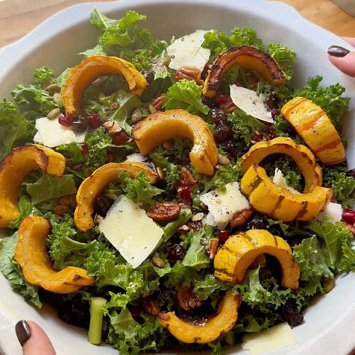 Roasted Delicata Squash Salad in a bowl with garnish.