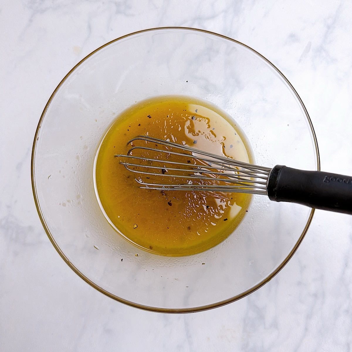Maple dressing whisked in a bowl.