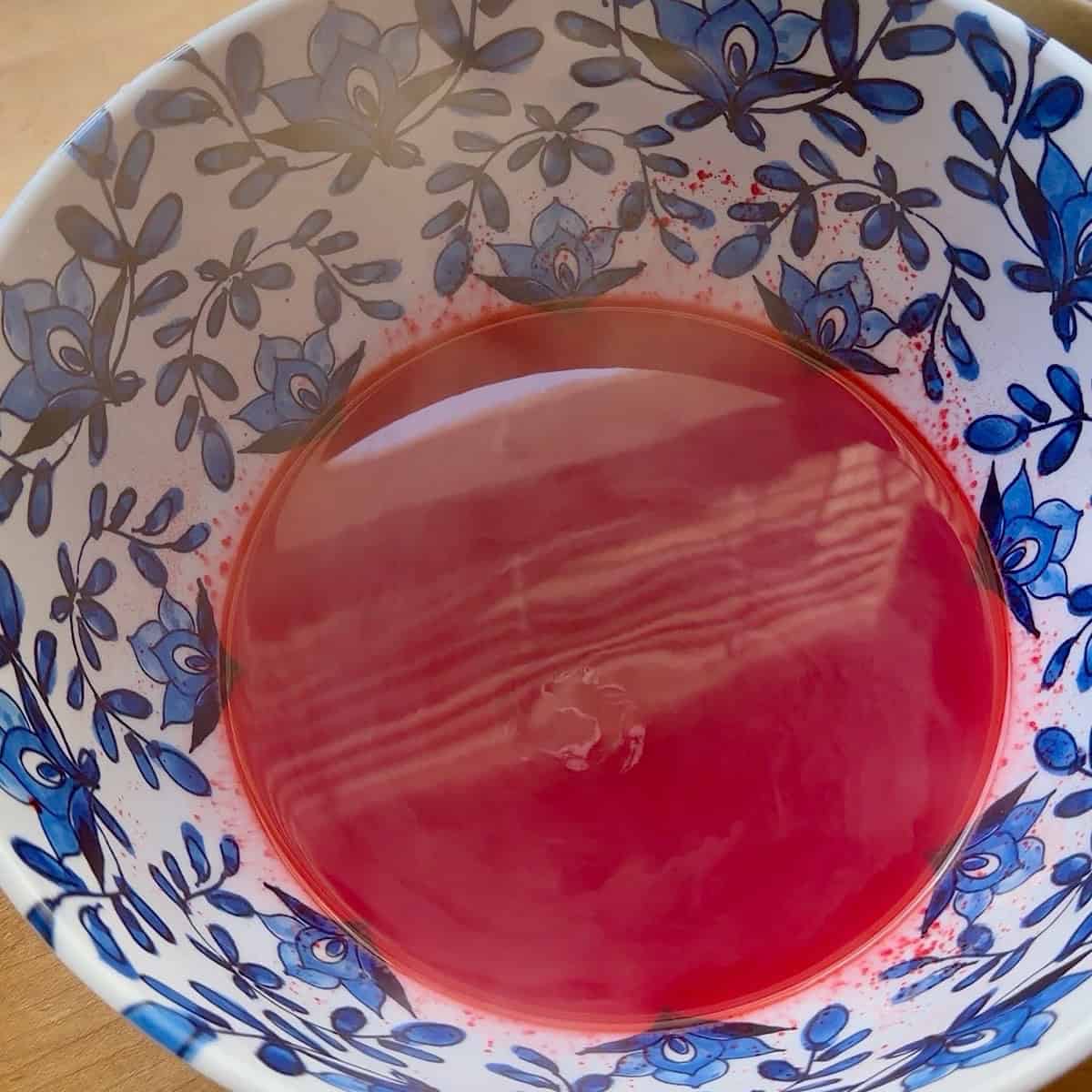 Raspberry jello powder whisked in with boiling water.