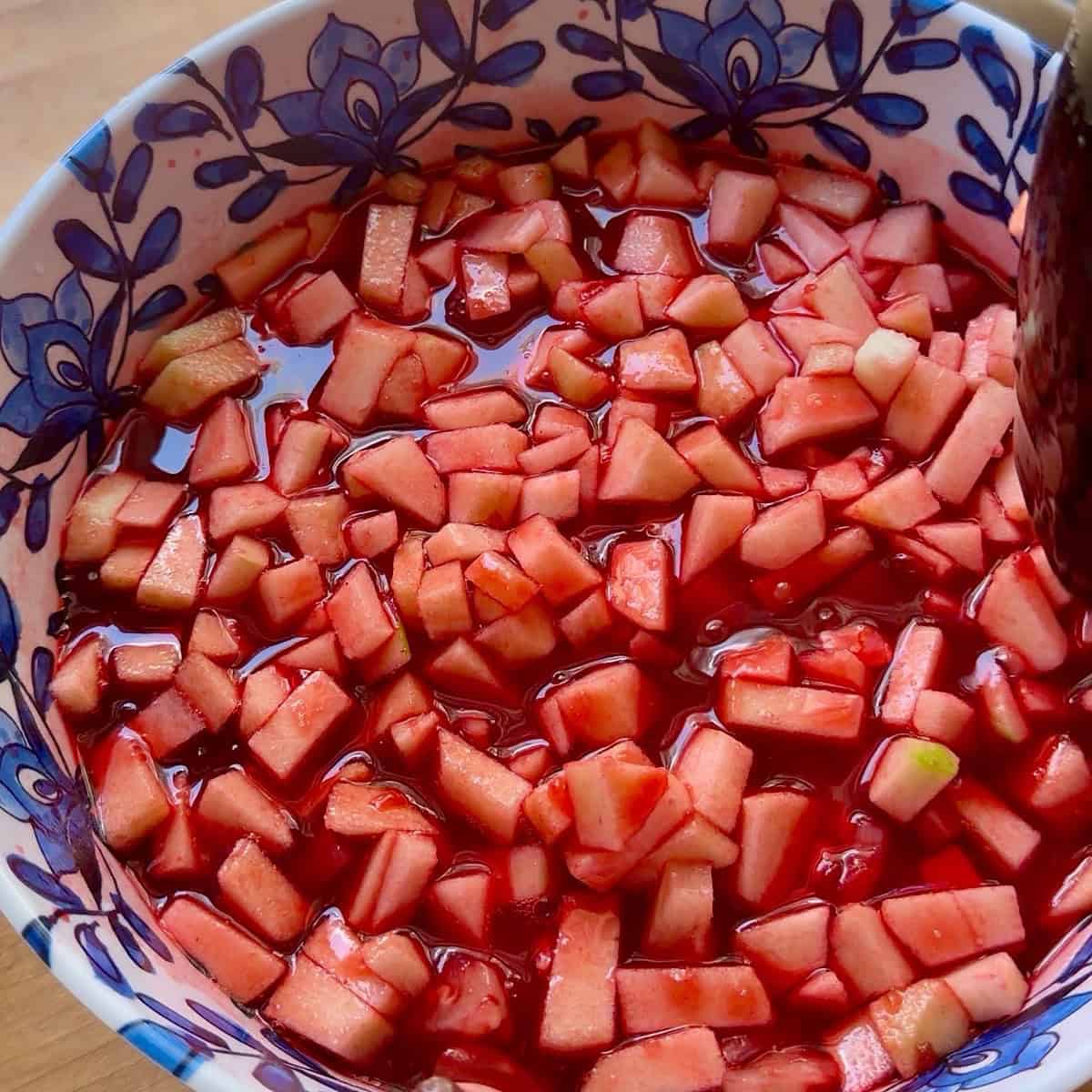 Pineapple and apple folded into the raspberry gelatin.