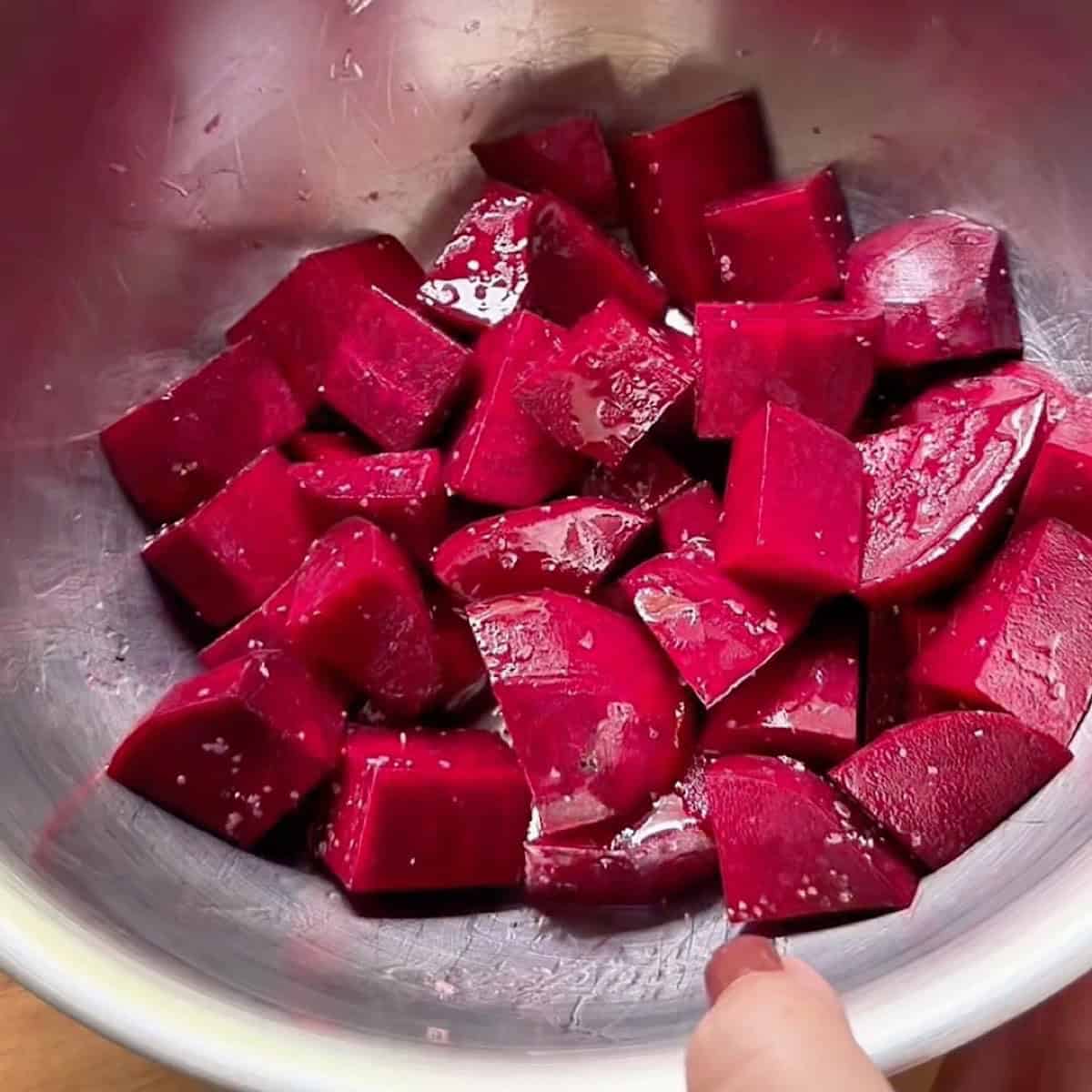 Cubed and seasoned beets in mixing bowl.