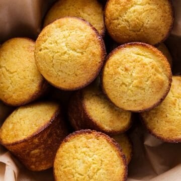 Sweet southern cornbread muffins in a bowl with parchment.
