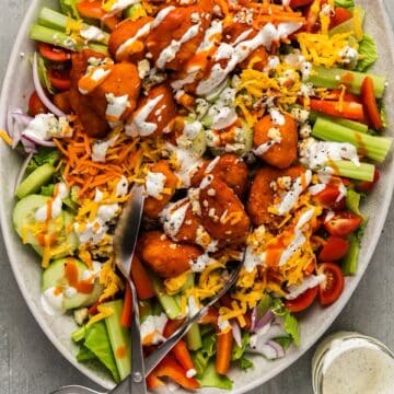 Buffalo chicken salad platter with buttermilk ranch dressing drizzled over top.