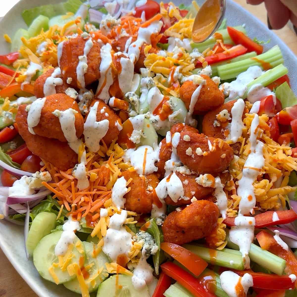 Buffalo chicken, cheeses, and dressing added.