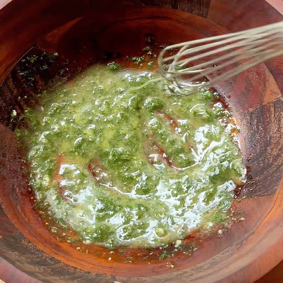 Whisking the lemon garlic dressing.