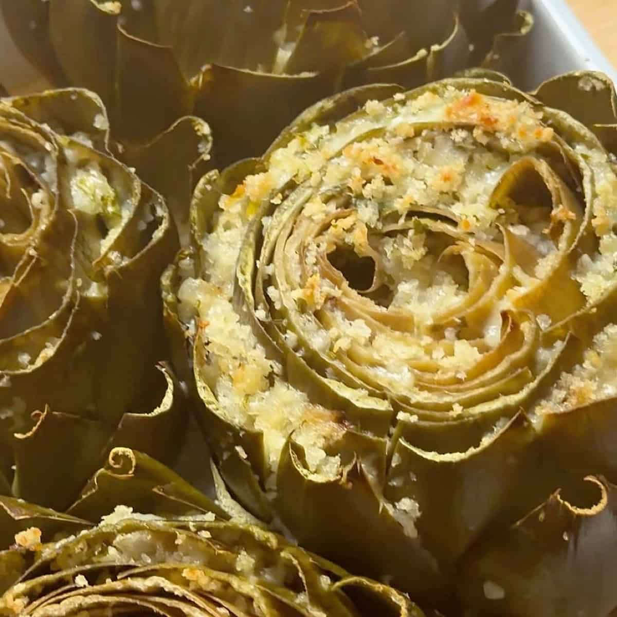 Cooked artichokes in a casserole dish.