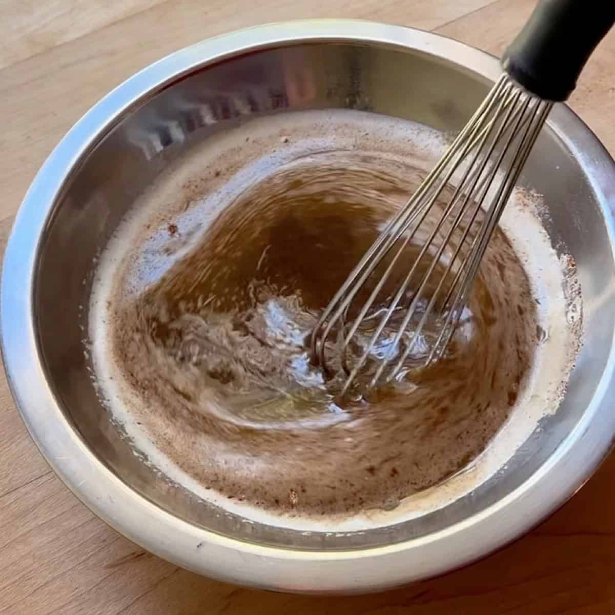 Whisking the Chex Mix seasoning with butter.