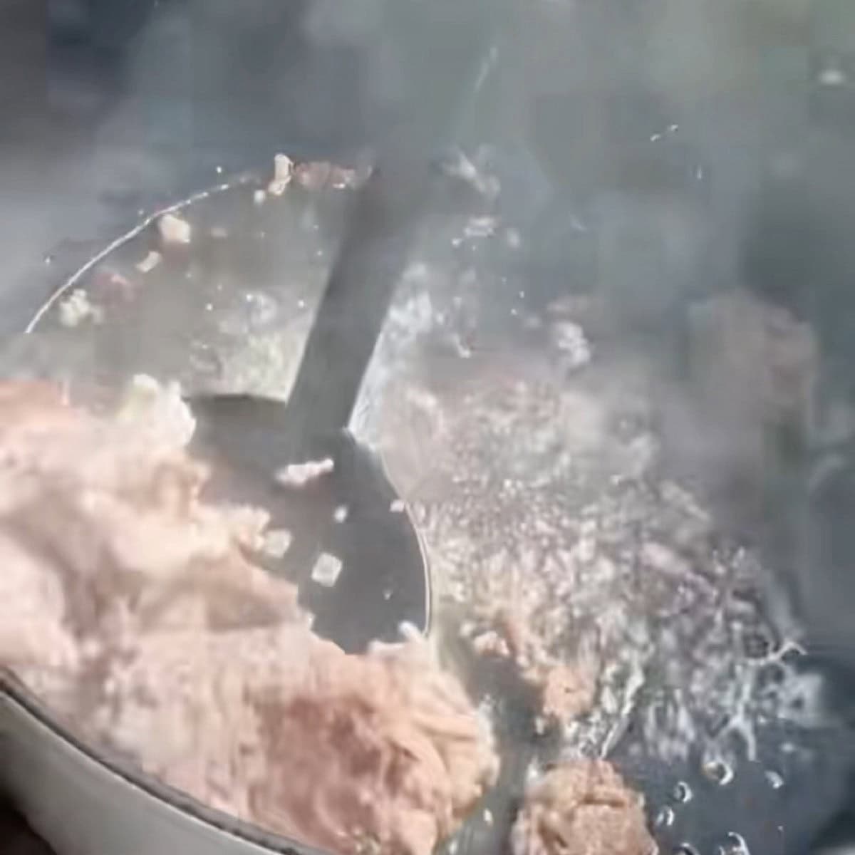 Browning the ground beef and ground pork in a dutch oven.