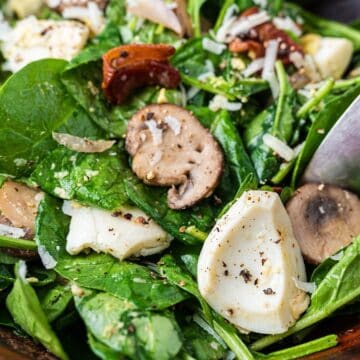 Warm spinach and bacon salad tossed in a bacon vinaigrette.