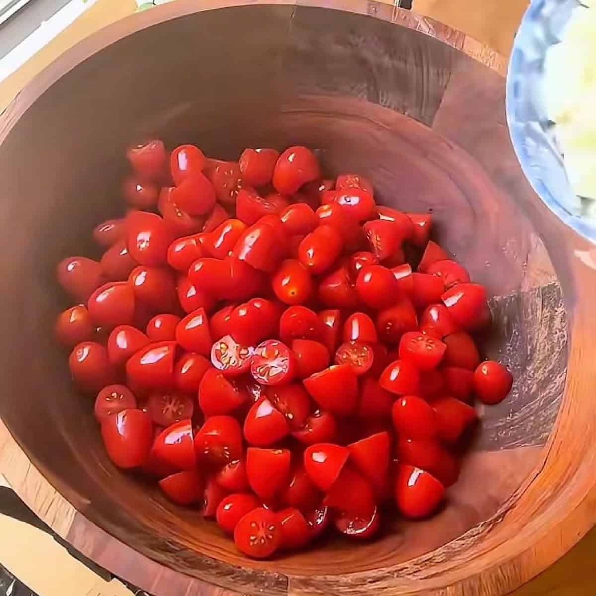 Halved tomatoes in a salad bowl.