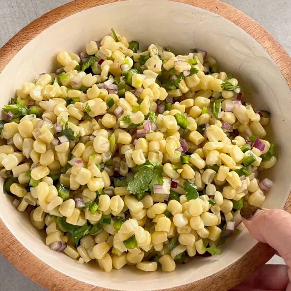Corn salsa chiled and in a decorative bowl.