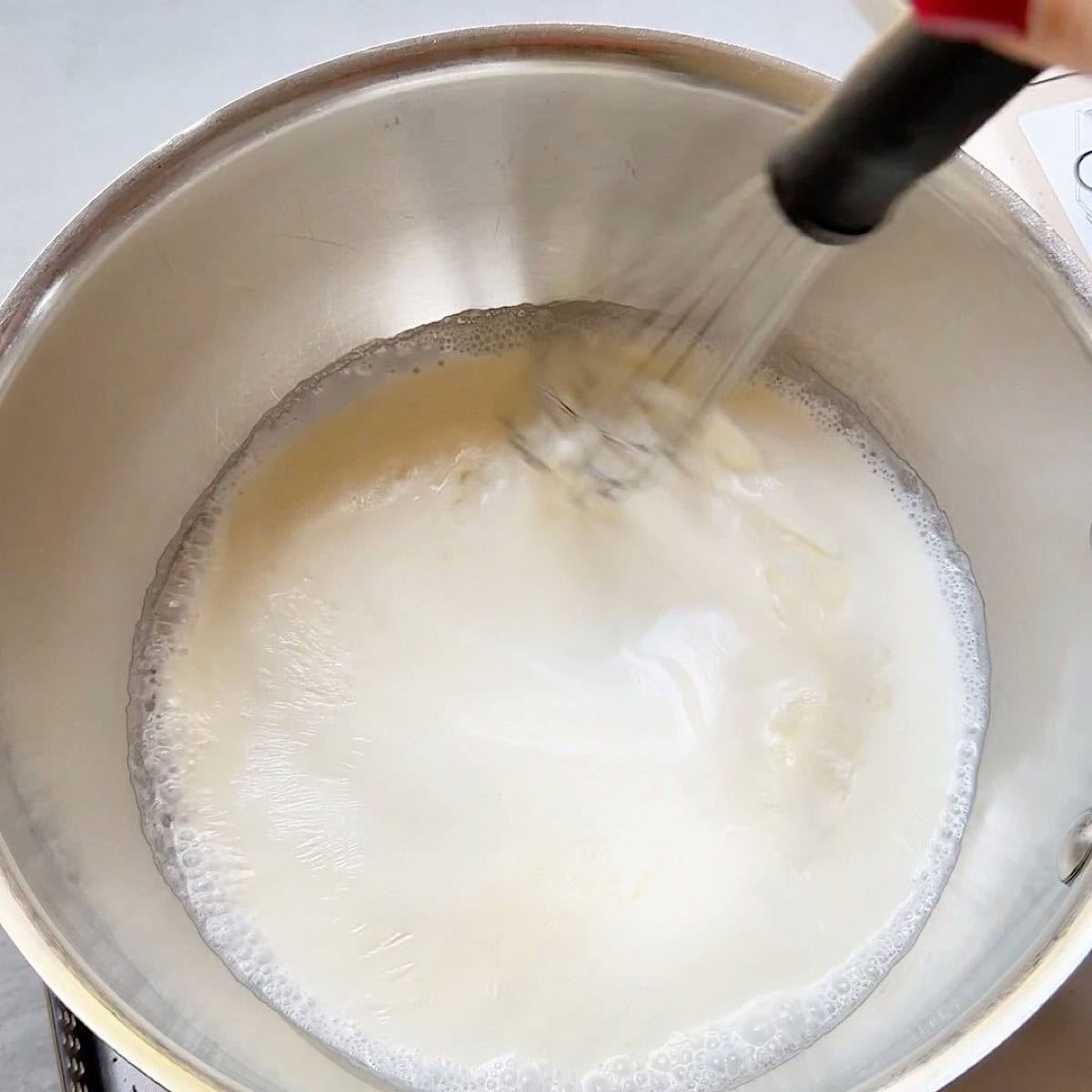 Heavy cream base being whisked with sodium citrate.