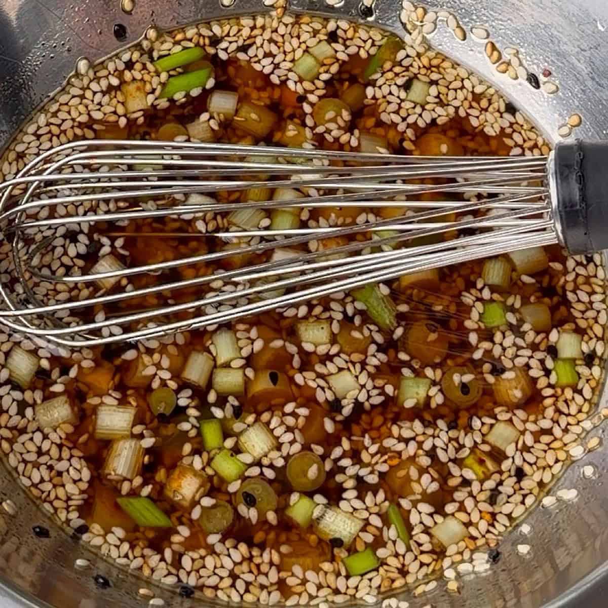 Hot oil with aromatics whisked.