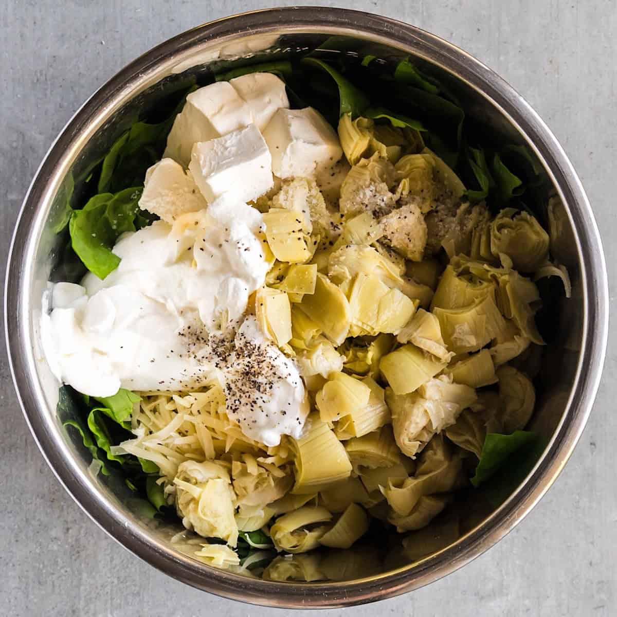 Fresh spinach, artichokes, and cheese added to the Instant Pot.