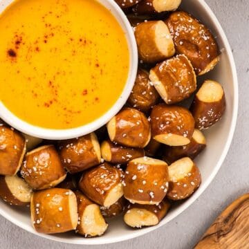 Soft pretzel bites in a bowl with a smaller bowl of beer cheese dip.