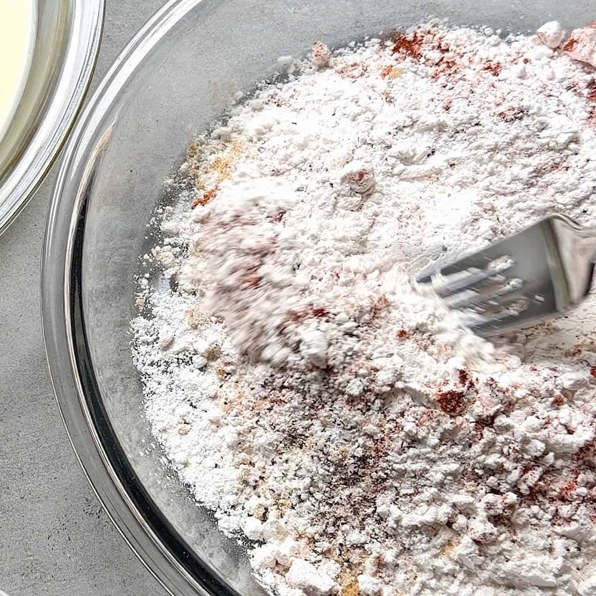 Combining seasoning with flour for dredging.