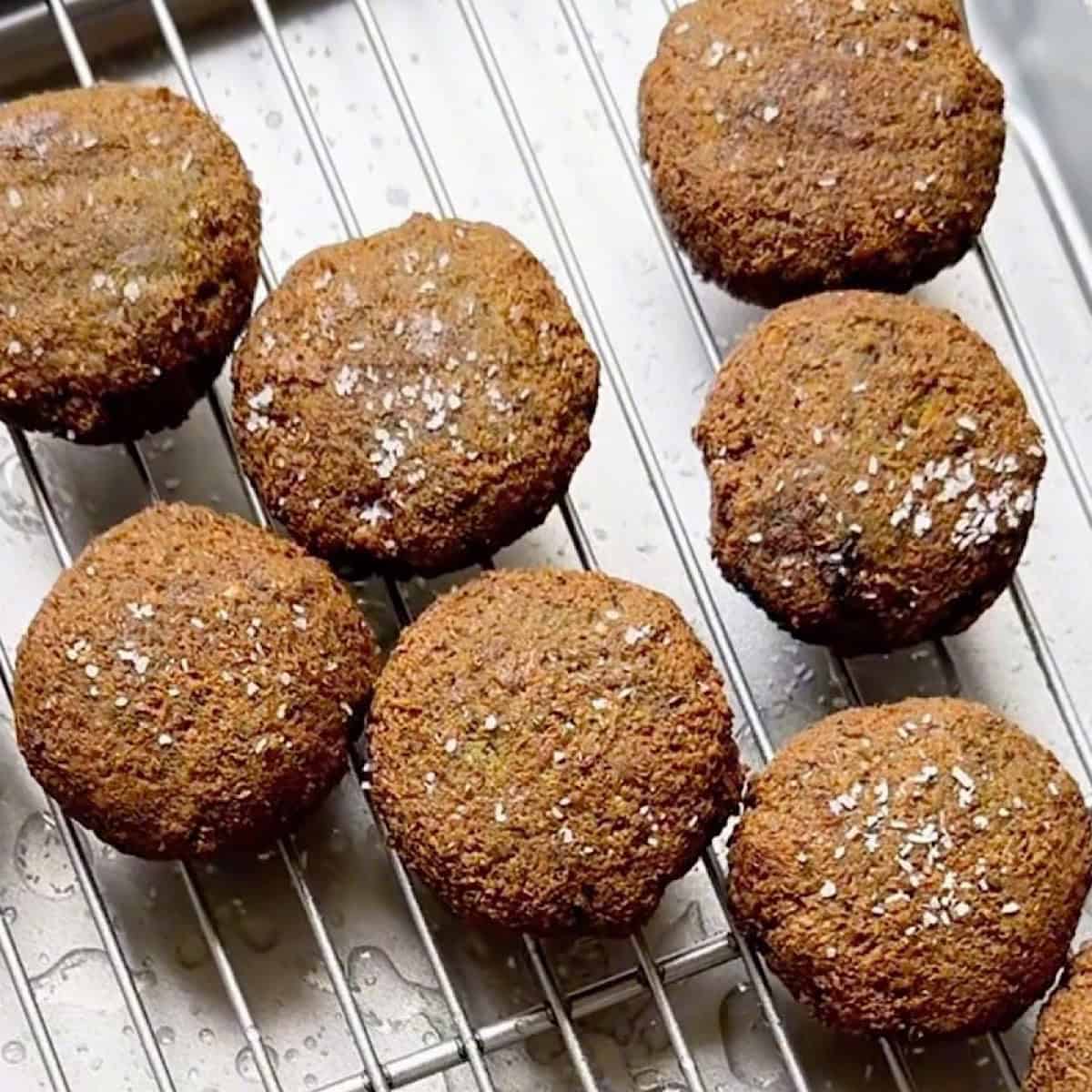 Fried falafel cooling on a wire rack.