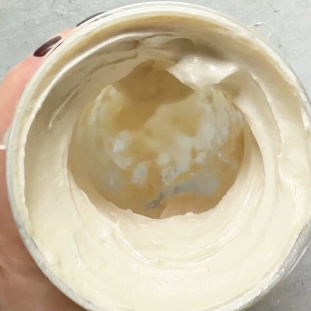 Lemon tahini dressing blended in a small blender.