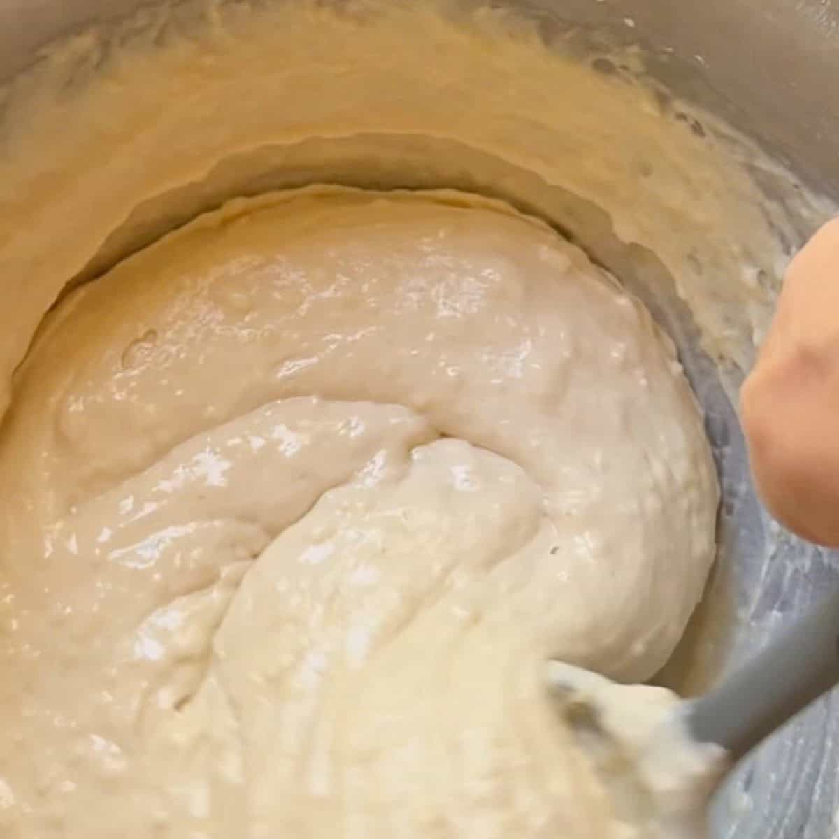 Pancake batter dry and wet ingredeints being stirred together.