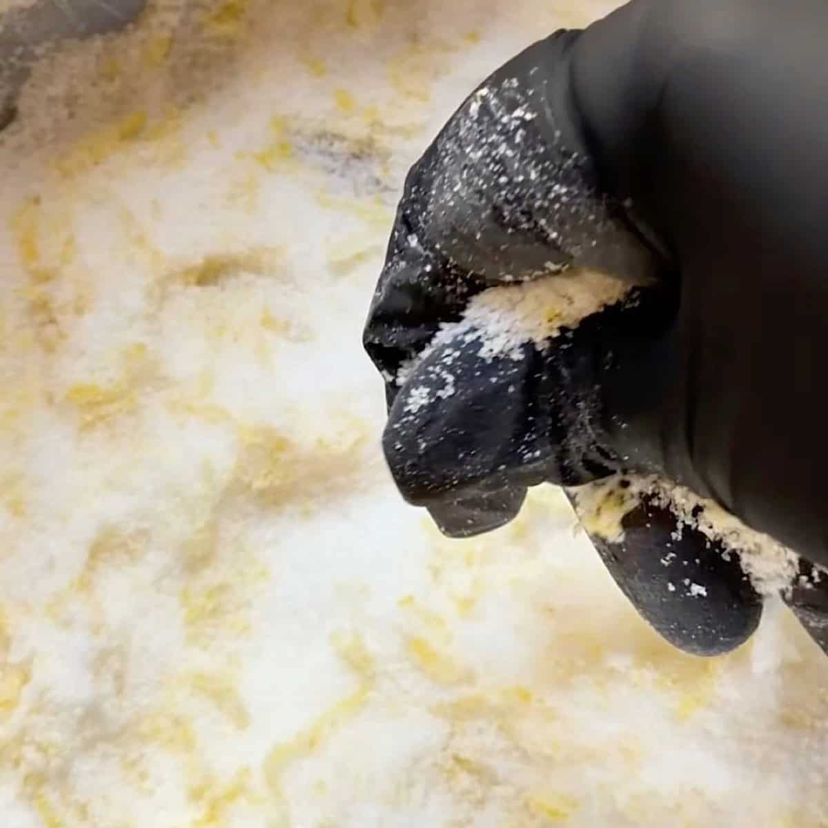 Infusing the lemon zest into the sugar by hand.