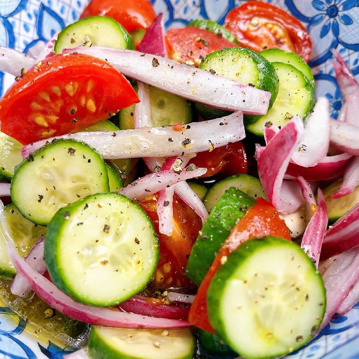 Southern Cucumber Tomato and Onion Salad in a blue decorative bowl.