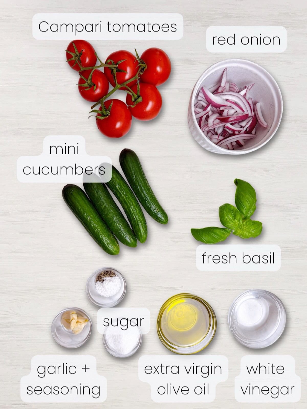 A labeled image of everything needed to make Southern tomato cucumber and onion salad.