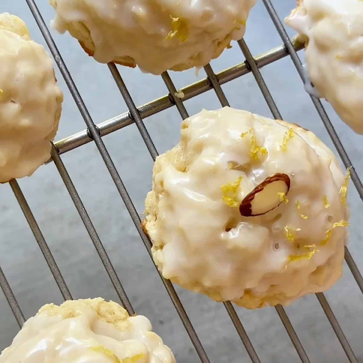 Baked lemon ricotta cookies with lemon glaze on a wire rack.