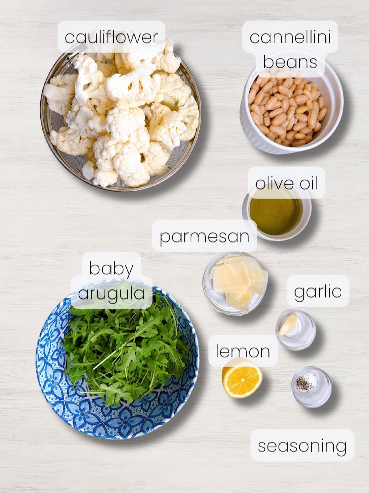 A labeled image of everything needed to make roasted cauliflower salad with white beans and lemon.