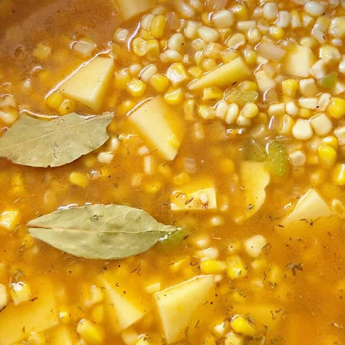Corn, potatoes, chicken broth, and seasonings simmering.