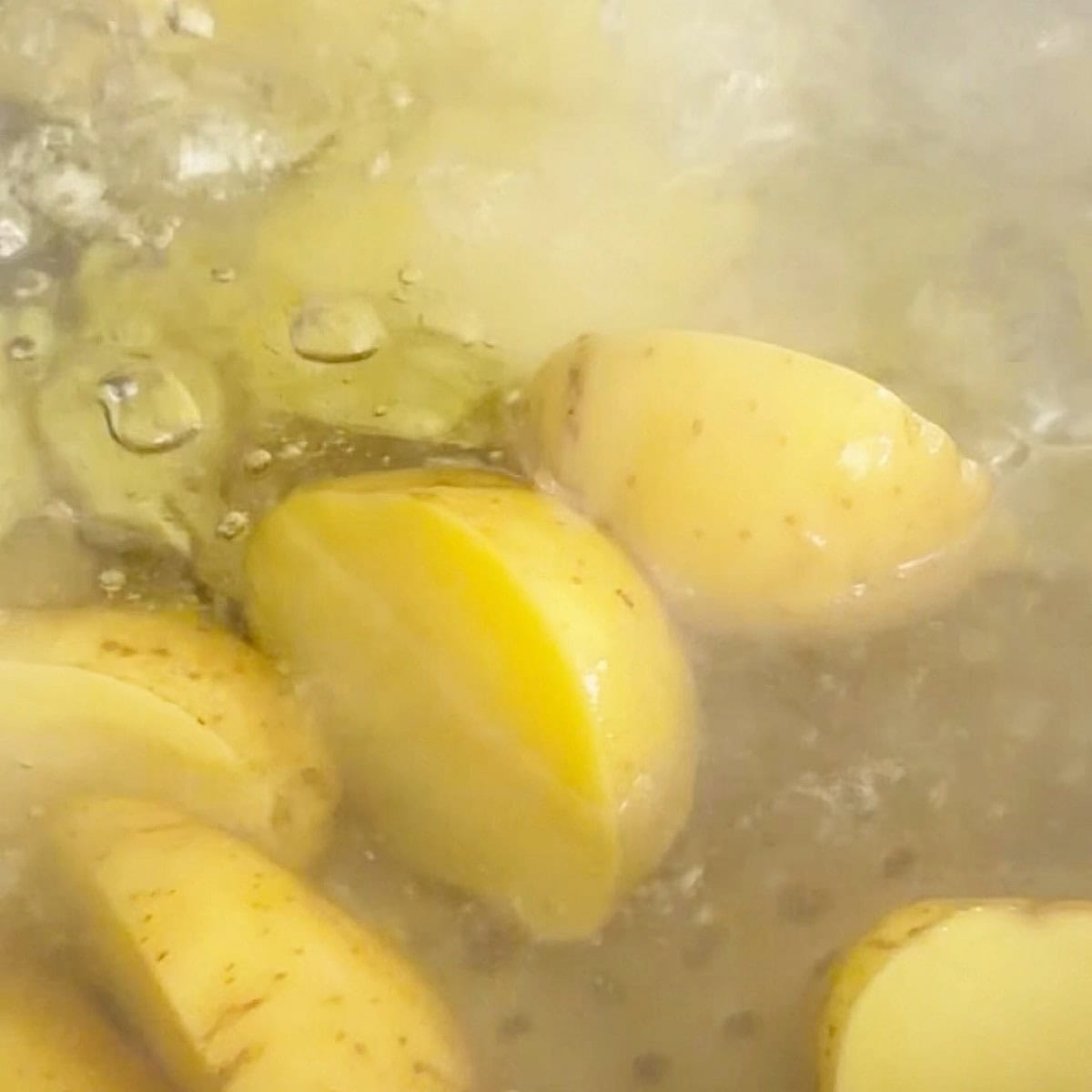 Yellow potatoes boiling.