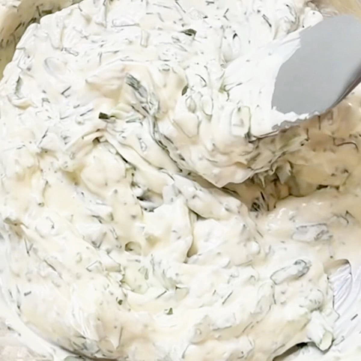 Greek yogurt dressing mixed in a bowl.