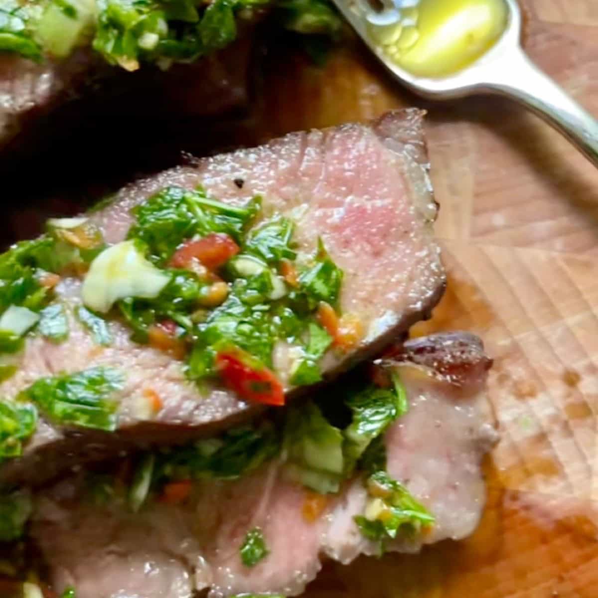 Cilantro chimichurri spread over sliced steak.