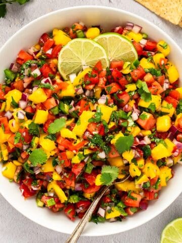 Fresh mango pico de gallo with lime and cilantro, perfect for salsa lovers.
