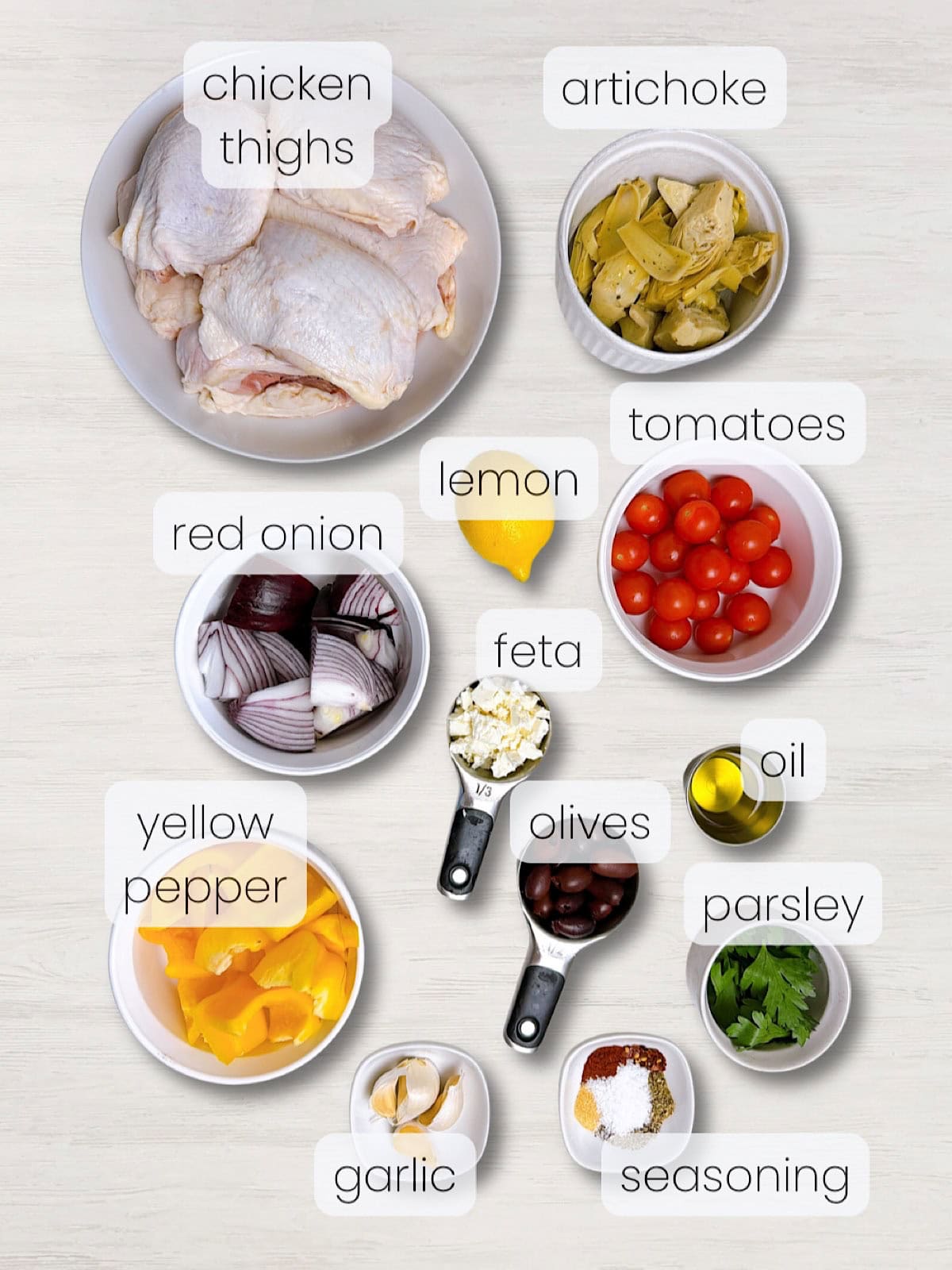 A labeled image of everything needed to make a mediterranean sheet pan chicken dinner.