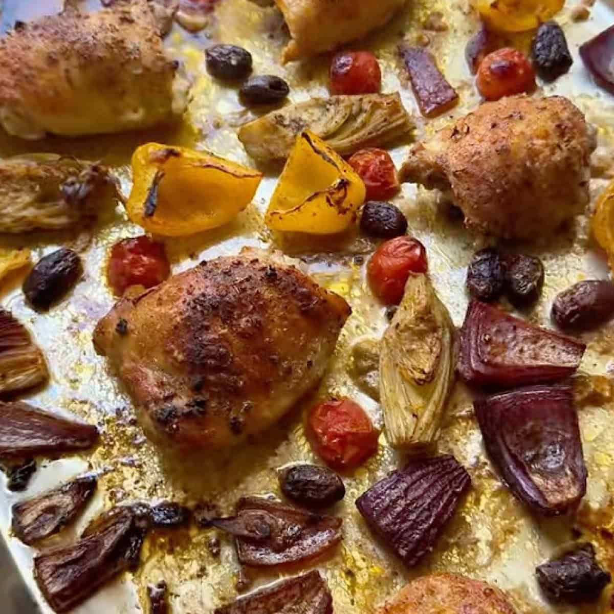 Roasted chicken and vegetables on the sheet pan.