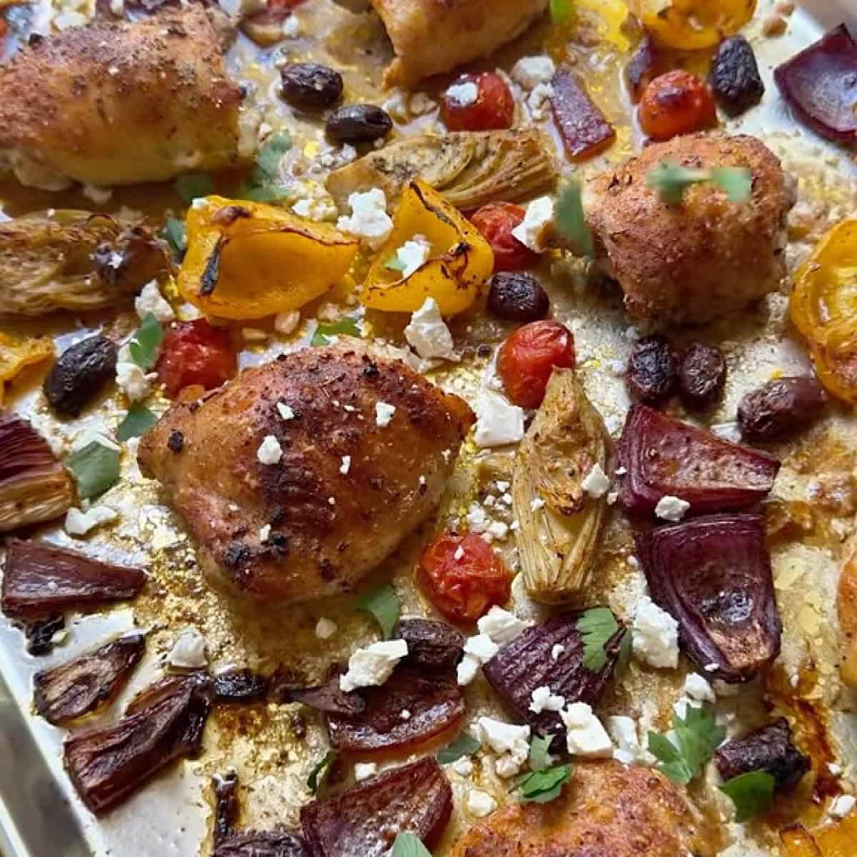 Parsley and feta cheese added to the Mediterranean sheet pan chicken dinner.