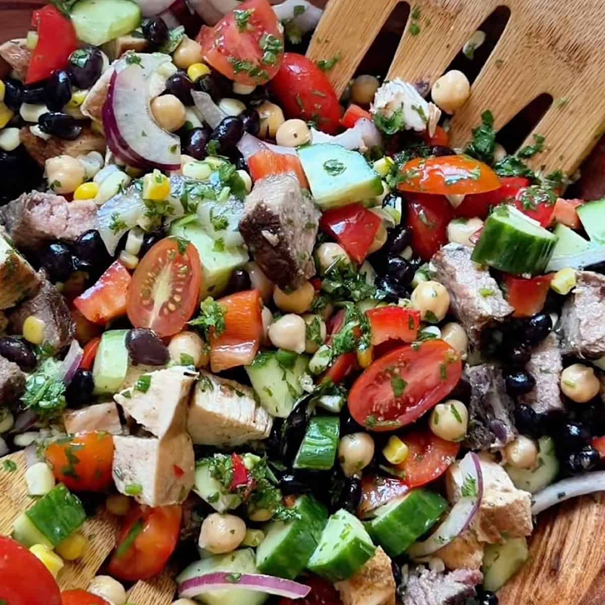 Chimichurri dressing added to salad and tossed gently.