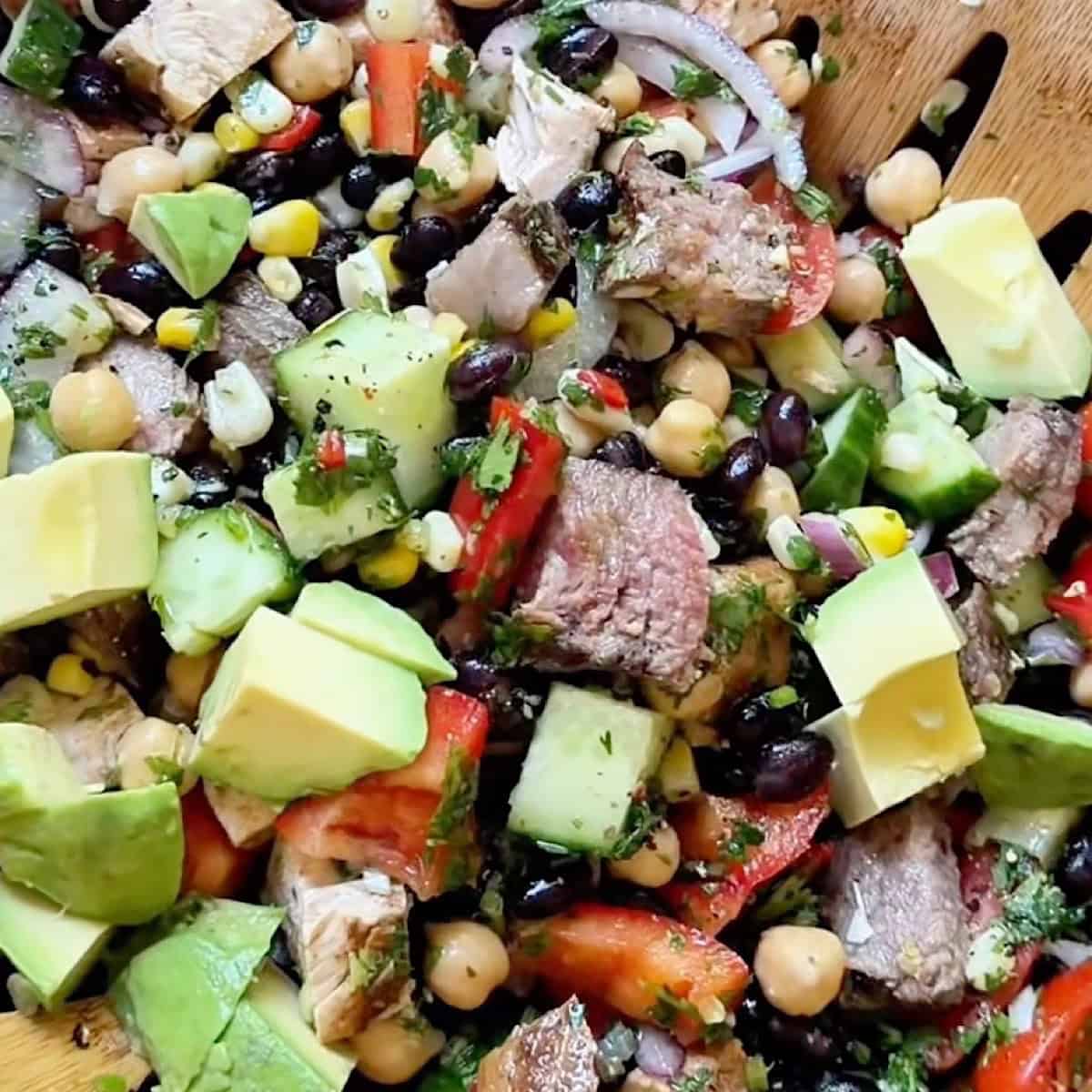 Avocado and lime juice added to the tossed chimichurri dense bean steak salad.