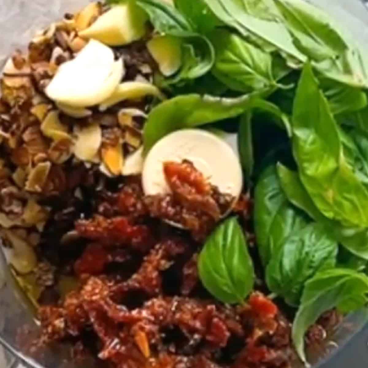 Sundried tomatoes, basil, and toasted almonds in a food processor before blending.