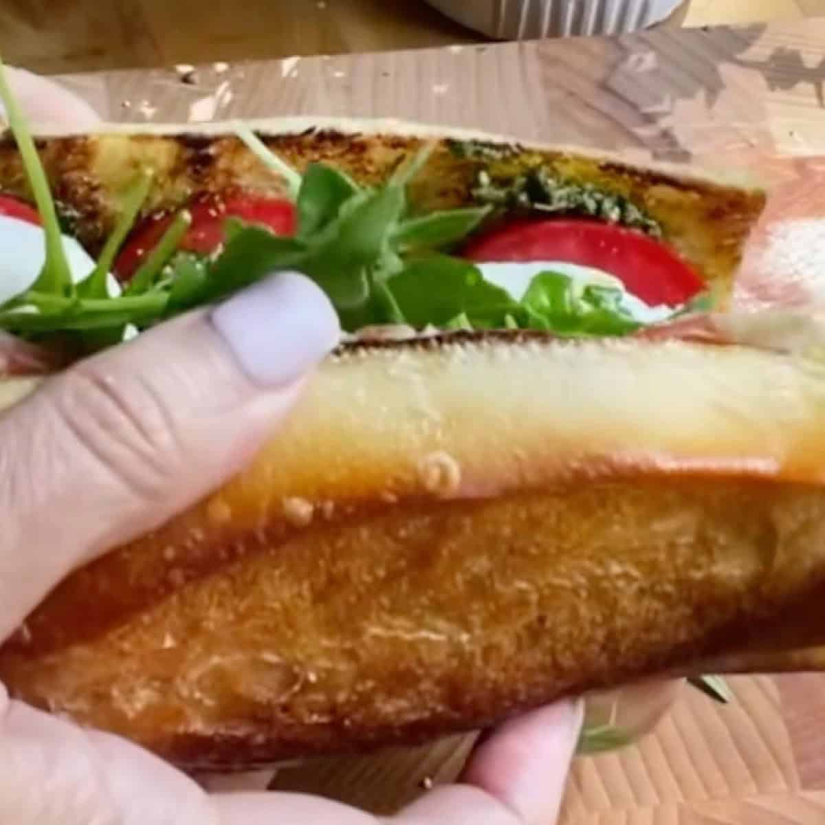 Closing the sandwich with bread on top.