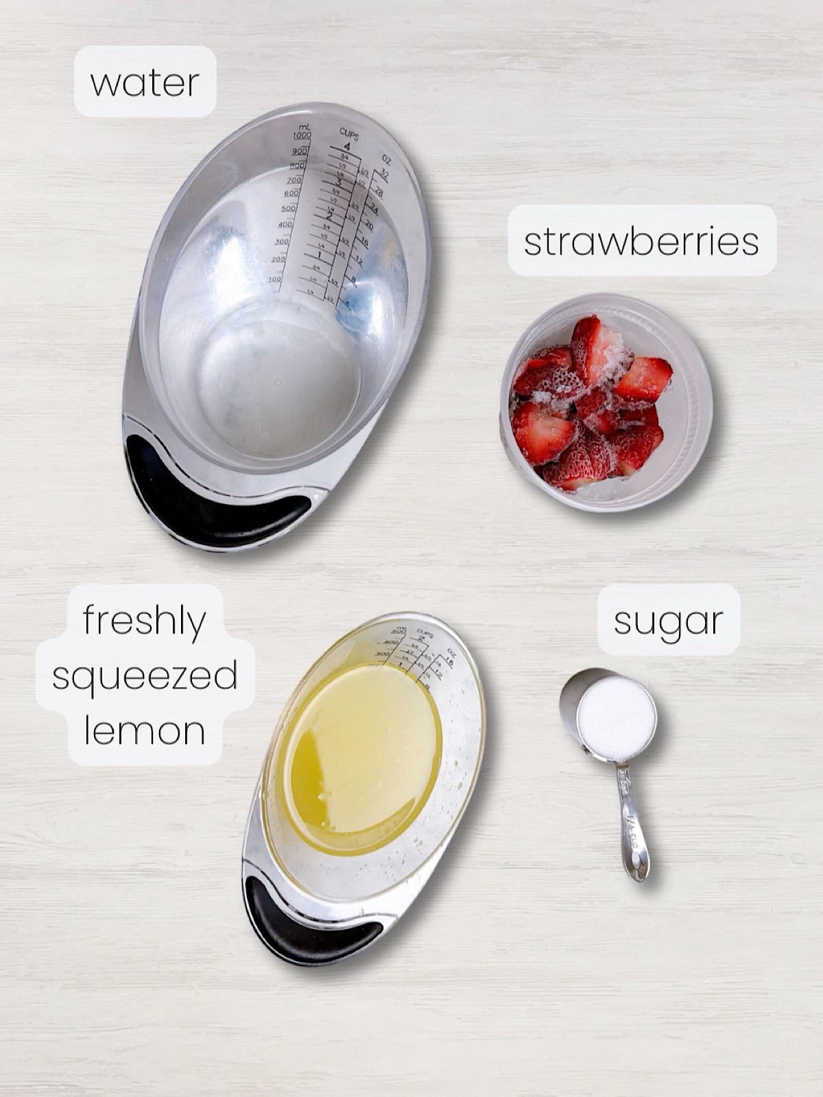A labeled image of everything needed to make fresh homemade strawberry lemonade.