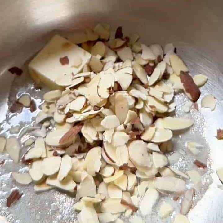Almonds in a skillet with butter.