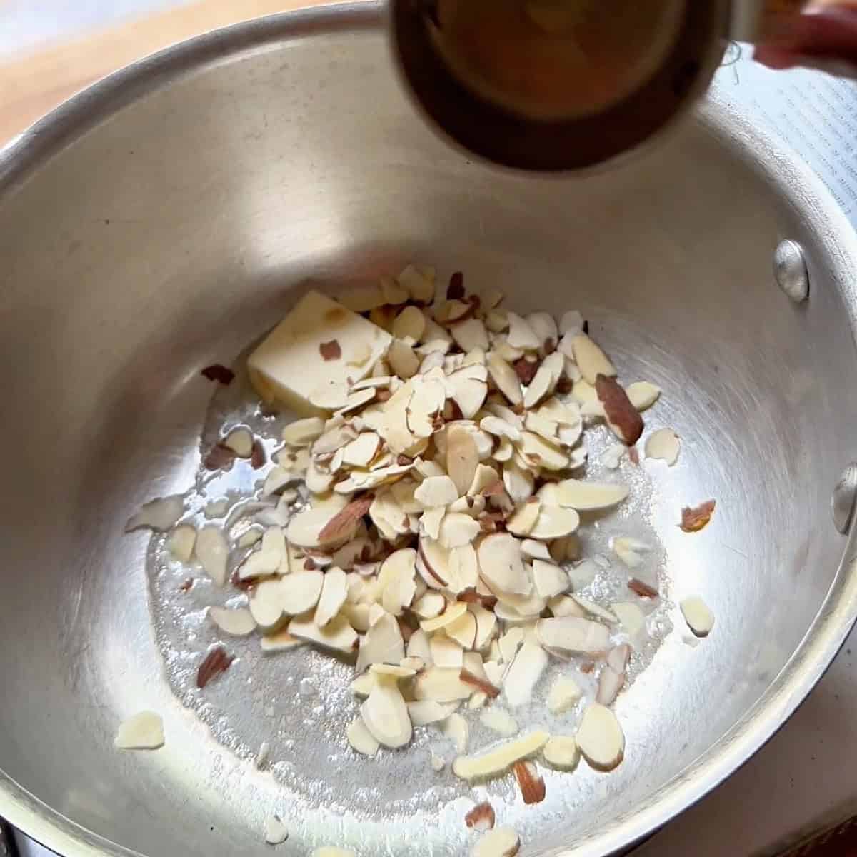 Preparing the butter toasted almonds.