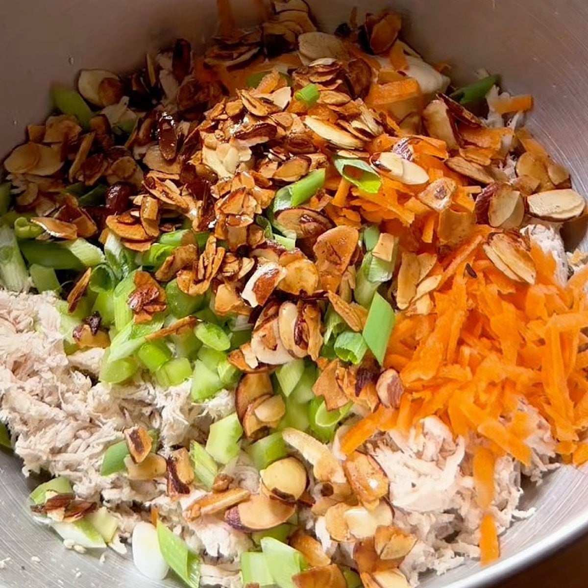 Honey chicken salad ingredients in a mixing bowl ready to combine.