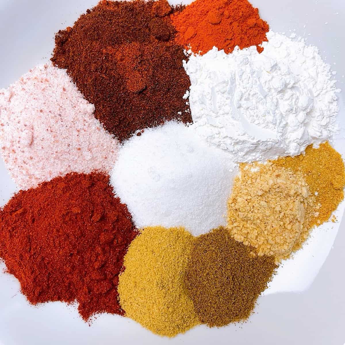 Fajita seasoning spice mix arranged on a plate to show color variation.